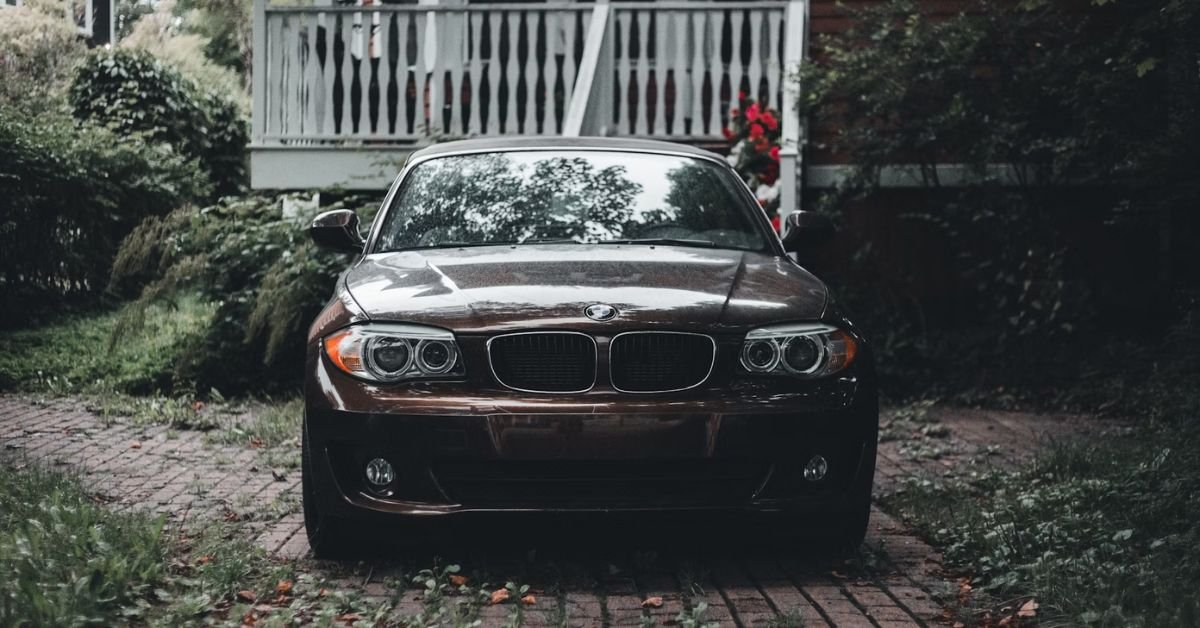 BMW on driveway in front of a house